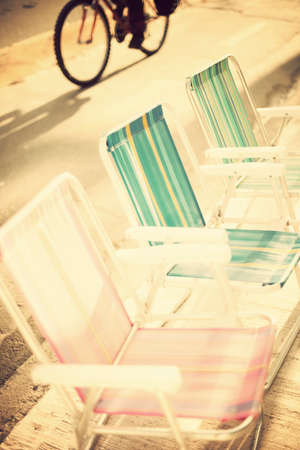 Outdoors chairs and bicycleの写真素材
