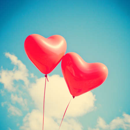 Two red heart-shaped balloonsの写真素材