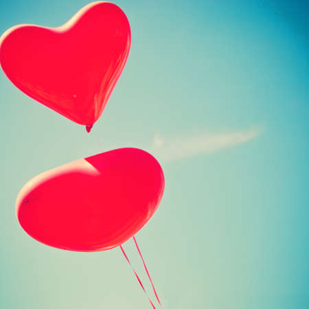 Two red heart-shaped balloonsの写真素材