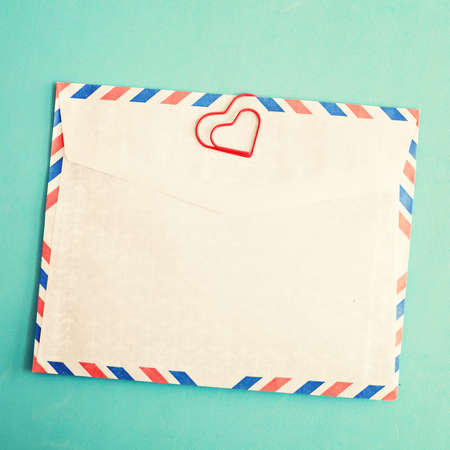 Mail envelope with heart-shaped clipの写真素材