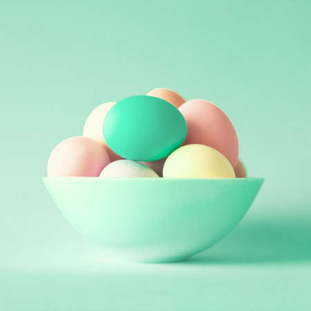 Colorful easter eggs in a bowlの写真素材