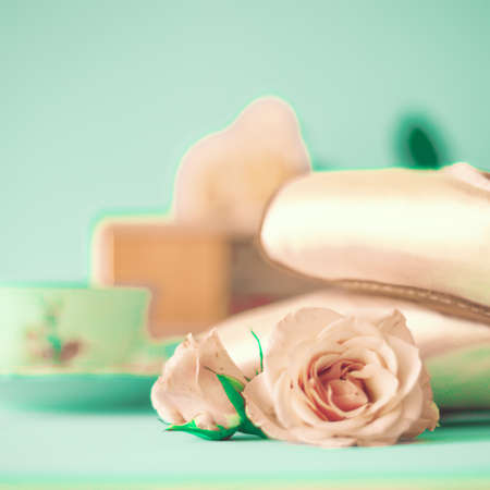 Ballet shoes, roses and a tea cupの写真素材