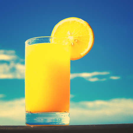 Orange juice by the seaの写真素材