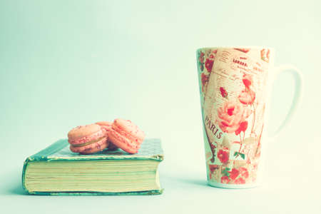 Pink macaroons over a vintage bookの写真素材