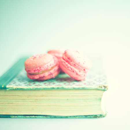 Pink macaroons over a vintage bookの写真素材