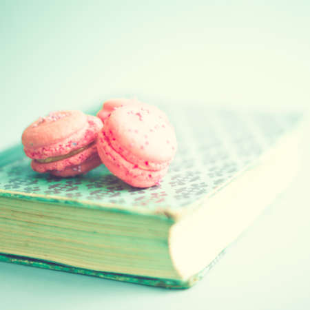 Pink macaroons over a vintage bookの写真素材
