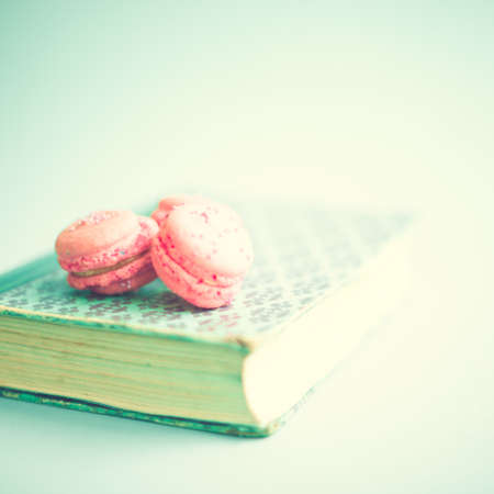 Pink macaroons over a vintage bookの写真素材