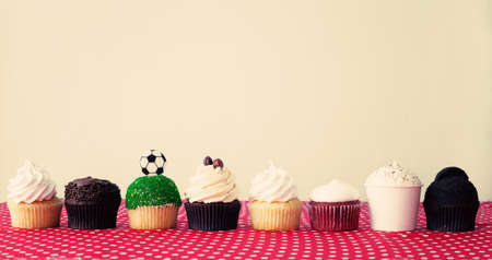 Various cupcakes over a polka dots tableclothの写真素材