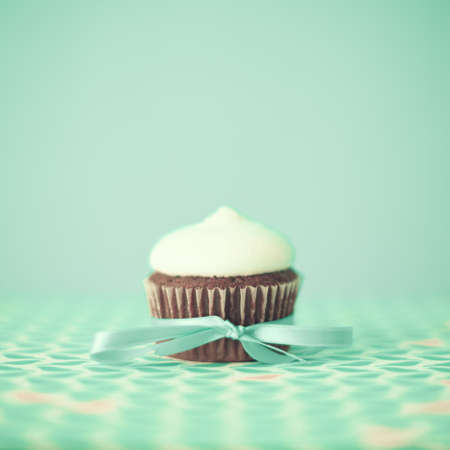 Red cupcake over turquoise backgroundの写真素材