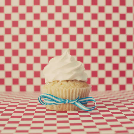 Vanilla cupcake over checkered backgroundの写真素材