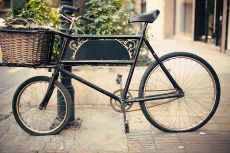 Vintage black bicycle with a basketの写真素材