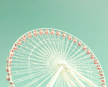 Vintage pastel ferris wheel over turquoise skyの写真素材