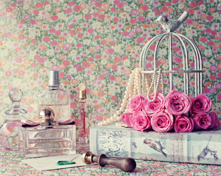 Roses over vintage book, perfume bottles and lacre sealの写真素材