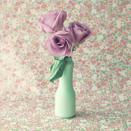 Roses in a vintage mint vaseの写真素材