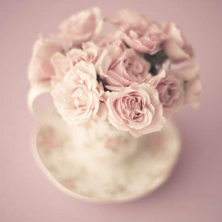 Vintage bouquet of roses in a coffee cupの写真素材