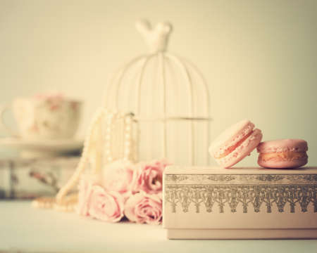 Vintage roses and pearls with macaroons over boxの写真素材