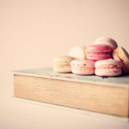 Macaroons over a vintage bookの写真素材