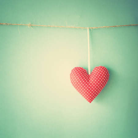 Cotton heart hanging from a clothes lineの写真素材