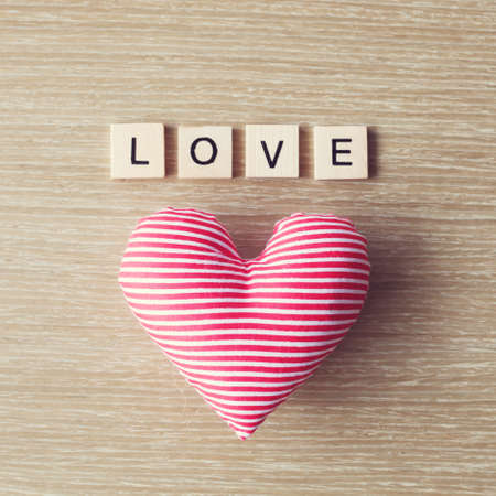 Cotton heart and love message over woodの写真素材