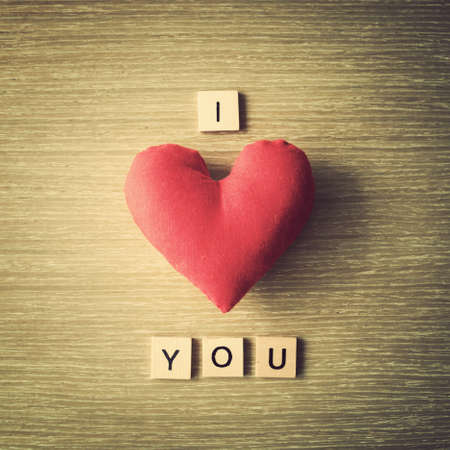 Cotton heart and love message over woodの写真素材