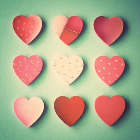 Nine hand-painted wood hearts over blue backgroundの写真素材