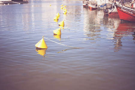 Buoys floating in a portの写真素材