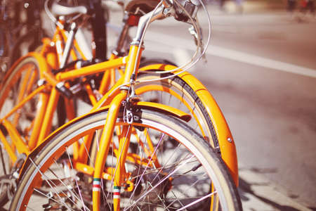 Yellow vintage bicycles in a sidewalkの写真素材