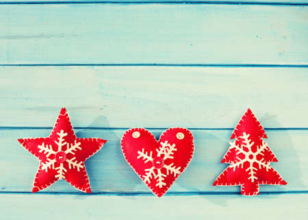 Vintage felt christmas ornaments over turquoise wood