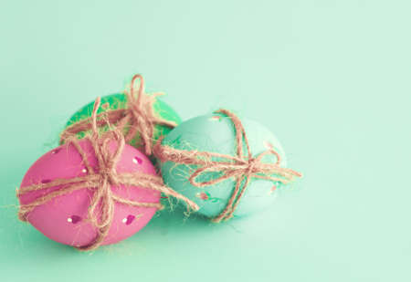Vintage pastel easter eggs over mint background