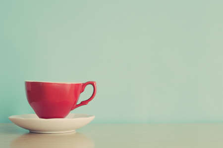 Vintage red coffee cup over a white dish