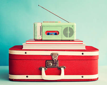 Vintage radio network over books and suitcaseの写真素材