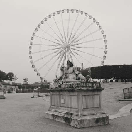 Ferris wheel in Tuileries Garden and sculptureの写真素材