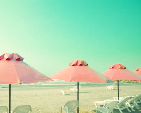 Vintage summer beach with parasolsの写真素材
