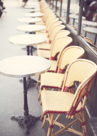 Outdoors chairs and tables of a cafe in Parisの写真素材
