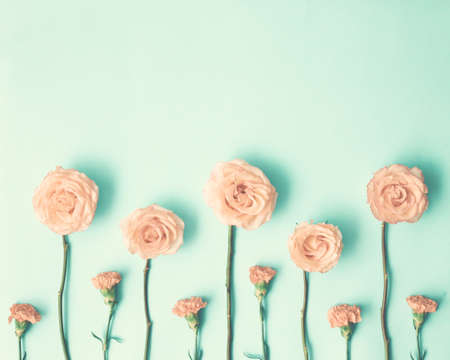 Pink roses and carnations on mint flat layの写真素材