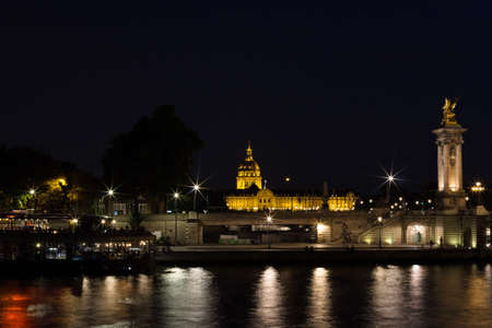Les Invalides and Seine River at nightの写真素材