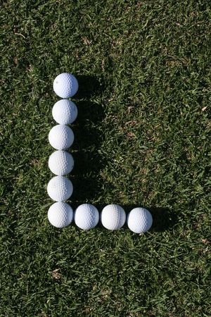 Golf ball lying close to the holeの写真素材