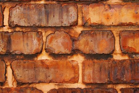 Old stone wall with rusty look
