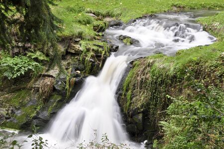 beautiful long watterfall. cascade in the morning sun light の写真素材