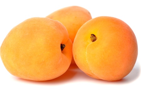 Three ripe, juicy apricots on a white background.の写真素材