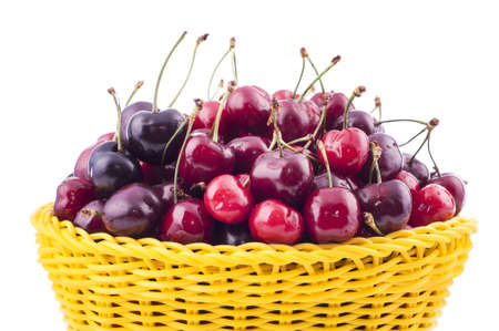 Sweet cherry in a basket on a white backgroundの写真素材