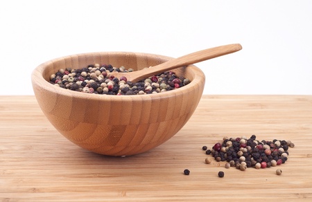 Pepper peas in a wooden cup on white Backgroundの写真素材