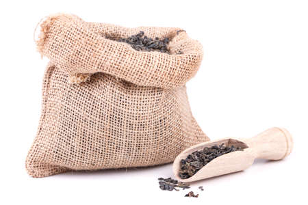 tea bag and a scoop on white backgroundの写真素材