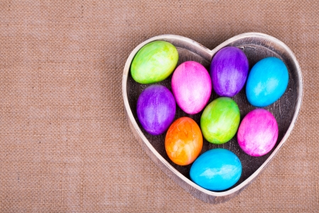 Colorful painted easter eggs on the wood  heartの写真素材