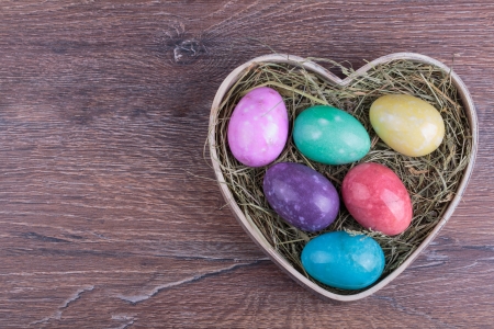 colored Easter eggs on a wooden backgroundの写真素材