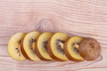 Gold kiwi fruit on a wooden backgroundの写真素材
