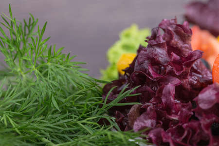 Fresh salad in white plate on wooden backgroundの写真素材