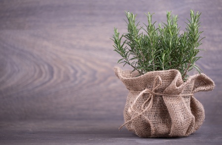rosemary in bag on a wooden backgroundの写真素材
