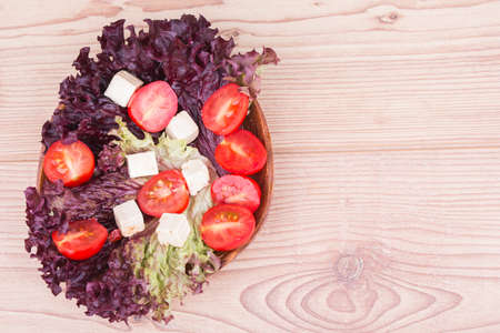 Fresh vegetables with tomatos on a wooden  backgroundの写真素材