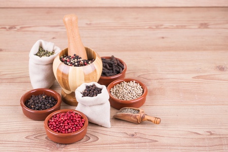 Assorted  spices in petri on wooden background